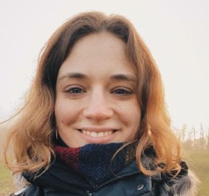 A close-up shot of a woman wearing a scarf