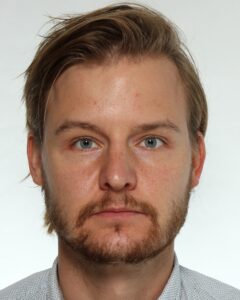 Feliks Gornischeff A man with a beard holds a neutral expression