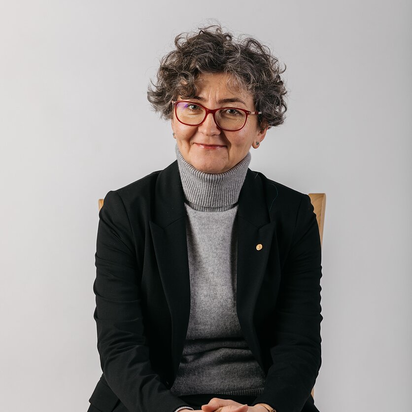 A smiling woman with short blonde hair