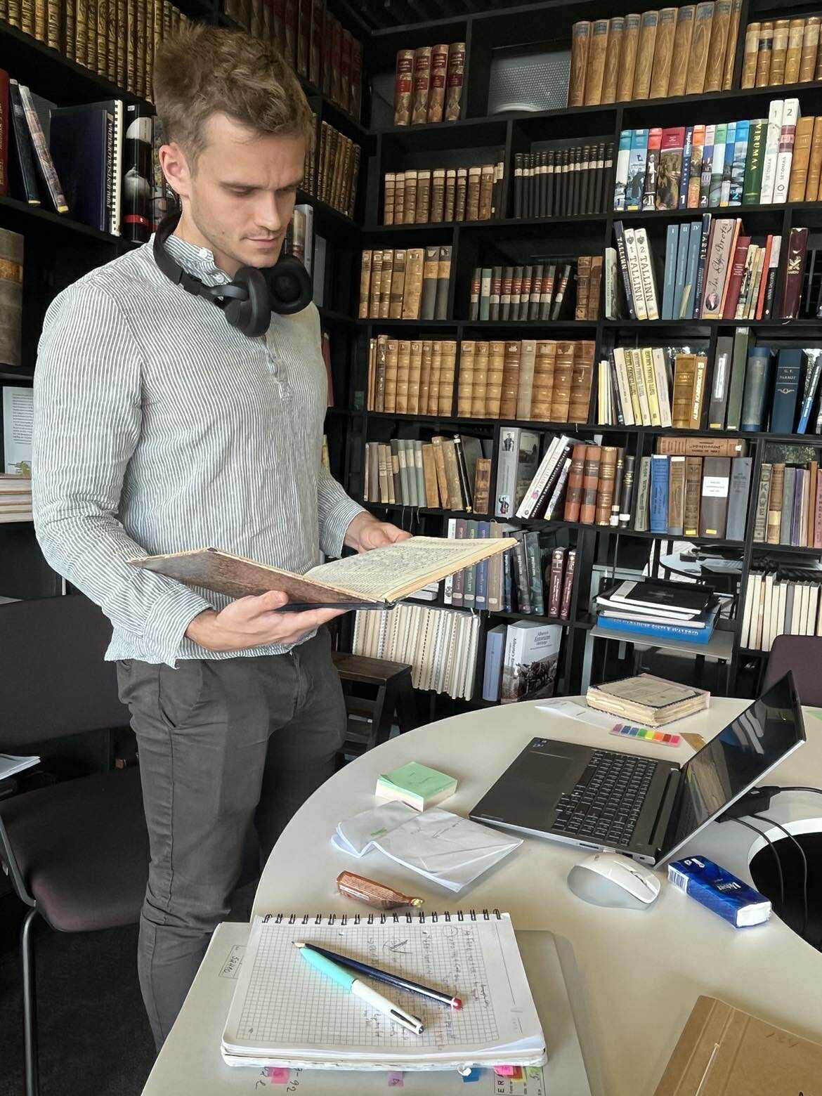 A man reading archival material