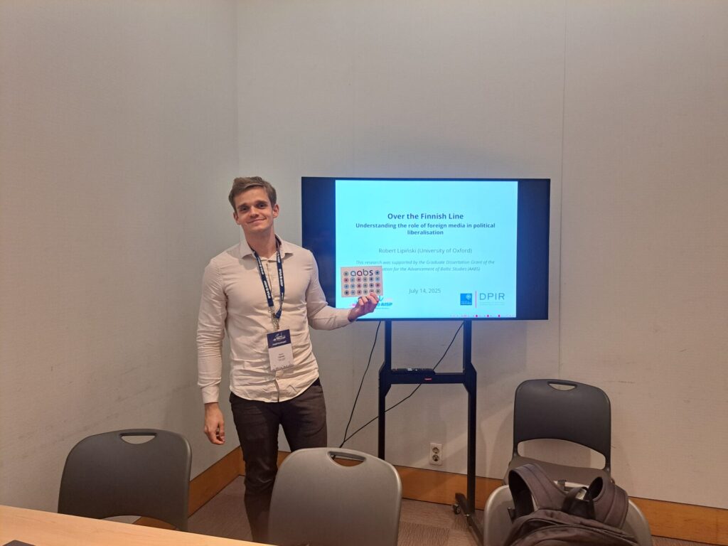 A man presenting in front of a screen