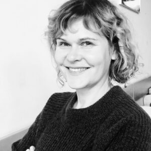 A black and white photo of a smiling woman