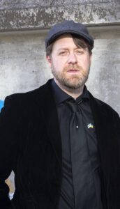 A man in a black suit