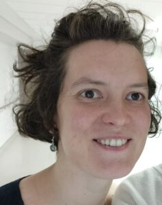A smiling woman with brown hair