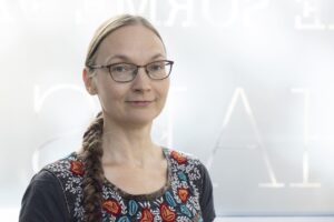 A smiling woman with glasses